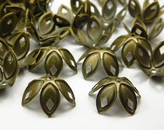 May include: A group of antique gold metal flower-shaped bead caps. The caps have a five-petal design with a small hole in the center.
