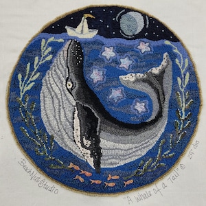 May include: A blue and gray whale with a tail curled up, swimming in a dark blue ocean with white stars. The whale is surrounded by green seaweed and orange fish. The text "A whale of a Tail" and "Beach Nut Studio" are visible in the image.