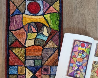 May include: A colorful rug with a geometric pattern. The rug is made of wool and has a variety of colors, including red, orange, yellow, green, blue, and purple. The rug is rectangular and has a fringe border.