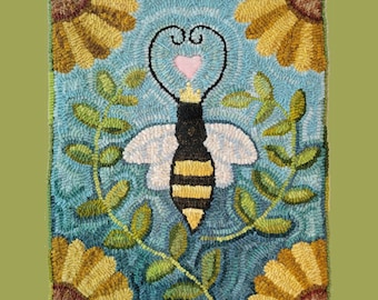 May include: A needlepoint rug depicting a bee with a heart and wings, surrounded by green leaves and yellow flowers on a blue background.