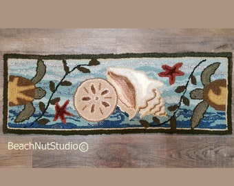 May include: A blue and green rug with a seashell, starfish, and two sea turtles. The rug has a light blue background with white waves and green vines.