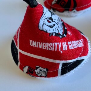 May include: Red and black fabric cone with a white bulldog mascot and the text "University of Georgia".