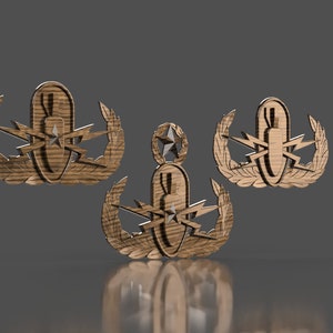 May include: Three wooden replicas of the Explosive Ordnance Disposal (EOD) badge. The badge features a bomb with lightning bolts and a laurel wreath.