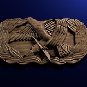 May include: A wooden carving of an eagle with wings spread, holding a lightning bolt in its talons. The eagle is surrounded by a wreath of leaves.