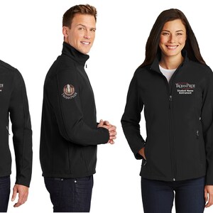 May include: Four people are wearing black soft-shell jackets with a logo embroidered on the left sleeve and the text "Trojan Pride" embroidered on the right chest. The logo features a horseshoe with a red and white design.