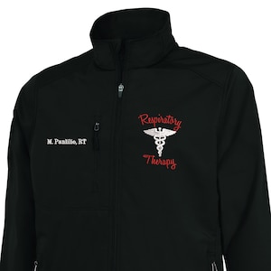May include: Black softshell jacket with a zipper closure and two zippered pockets. The jacket has a white embroidered caduceus symbol and the text "Respiratory Therapy" in red. The name "M. Panlillo, RT" is embroidered on the left chest.