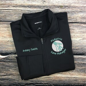 May include: Black zippered jacket with a white circle logo that says "Pediatric Case Manager" with a hand holding a heart inside the circle. The text "Ashley Smith" is embroidered on the left side of the jacket.