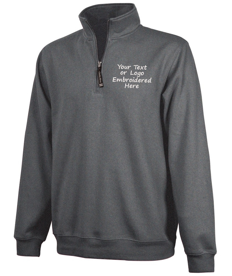 May include: A charcoal gray 1/4 zip pullover sweatshirt with a white embroidered design that says "Your Text or Logo Embroidered Here".