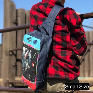 May include: A small denim crossbody bag with a patchwork design featuring a blue and white geometric pattern, a pink and red floral pattern, and a black and white space scene. The bag has a black strap and a zipper closure. "Small Size" is written in white text on a black background at the bottom of the image.