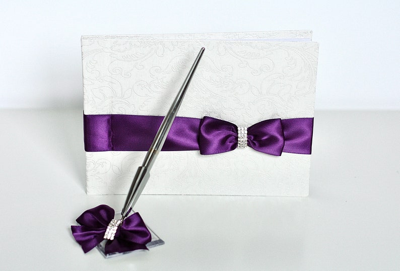 Purple-themed wedding reception supplies - plum wedding guest book and pen