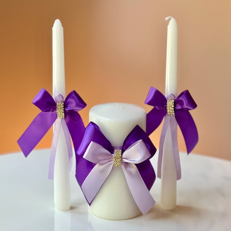 Purple-themed wedding ceremony supplies - purple unity candles.