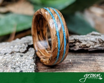 Tennessee Whiskey Barrel Spiral Grain Wood Ring with crushed Turquoise Inlay. Handmade, Custom, Wooden Wedding Bands by Grown Rings.