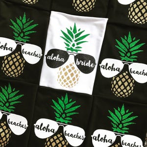May include: A set of black and white t-shirts with a pineapple design and the text "Aloha beaches" and "Aloha bride".
