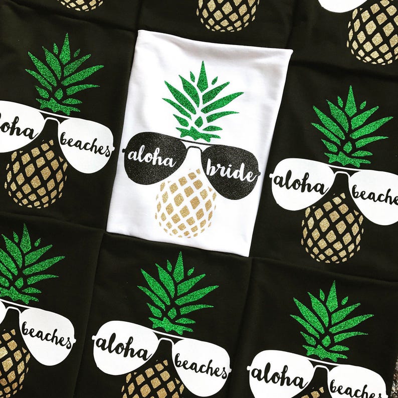 May include: A set of black and white t-shirts with a pineapple design and the text "Aloha beaches" and "Aloha bride".