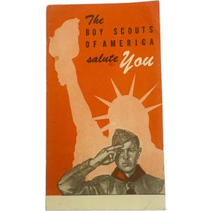 May include: Vintage Boy Scouts of America pamphlet with an orange background. The pamphlet features an illustration of a Boy Scout saluting, with the Statue of Liberty in the background. Text reads "The Boy Scouts of America salute You."