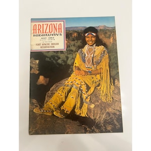 May include: A vintage July 1962 Arizona Highways magazine featuring a cover photograph of a person wearing a yellow fringed garment with intricate beadwork, sitting on a rock. The text reads Arizona Highways, July 1962, Fifty Cents, Fort Apache Indian Reservation.