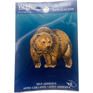May include: A self-adhesive appliqué patch featuring a detailed embroidered grizzly bear in shades of brown and black. The patch is packaged in a blue and white Wrights brand package. The package includes the words "APPLIQUE" and "APPLICATION".