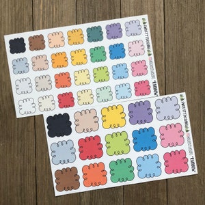 May include: Two sheets of colorful stickers with a rainbow theme. Each sticker is a square with a wavy border and a different color. The stickers are perfect for adding a pop of color to planners, journals, and other craft projects.