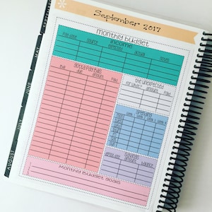 May include: A pink and blue monthly budget planner with sections for income, bills, spending, savings, and budget goals. The planner is for September 2017.
