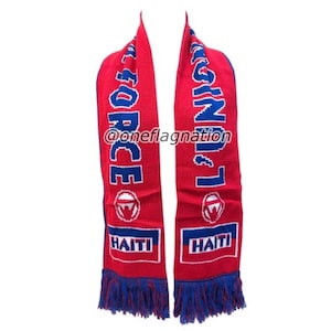 May include: Red and blue knitted scarf with the words "Haiti" and "Force" on it. The scarf has blue tassels on the ends.