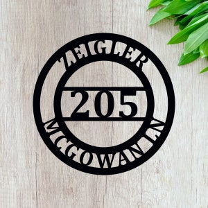 May include: Black metal house number sign with the name "Ziegler McGowan" and the number "205" in a circle.