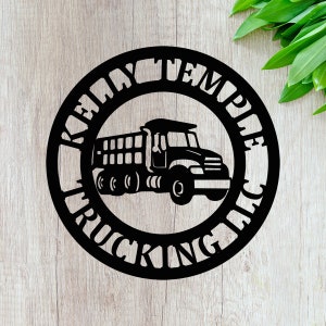 May include: Black metal sign with the text "Relay Temple Trucking Co." in a circle around a silhouette of a dump truck.