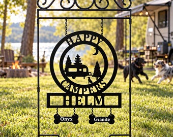 May include: A black metal garden sign featuring a circular cutout with a camper, trees, and a crescent moon. The text reads "HAPPY CAMPERS" and "HELM". Below, two bone-shaped plaques hang from chains, engraved with the names "Onyx" and "Granite".