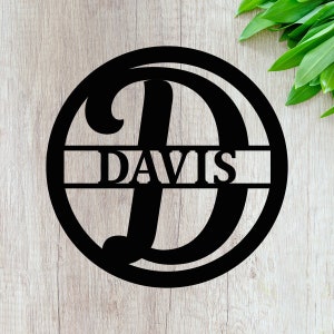 May include: Black metal circle with a large letter D and the name DAVIS written across the center.