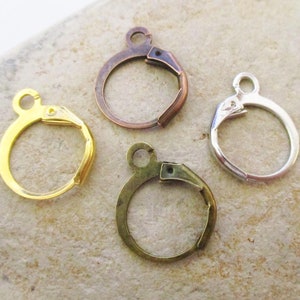 May include: Four earring hooks in different finishes: gold, bronze, silver, and antique brass. The hooks are made of metal and have a spring-loaded clasp.