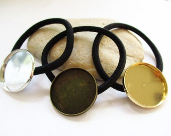 May include: Three black elastic hair ties with metal round embellishments. One embellishment is silver, one is gold, and one is bronze.