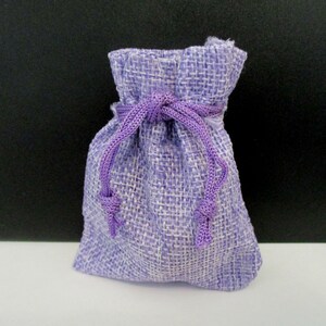 May include: A small purple burlap drawstring bag with a purple ribbon.