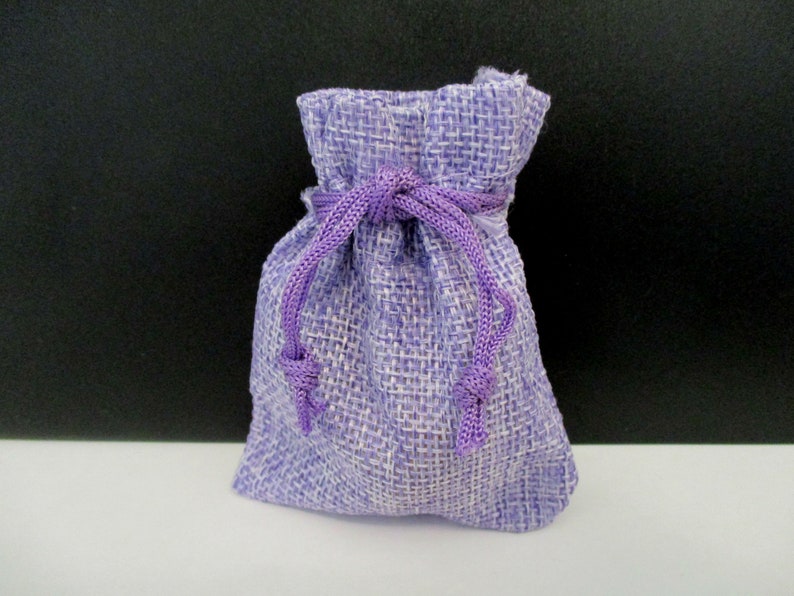 May include: A small purple burlap drawstring bag with a purple ribbon.