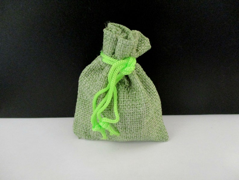 May include: A small green burlap drawstring bag with a bright green drawstring.
