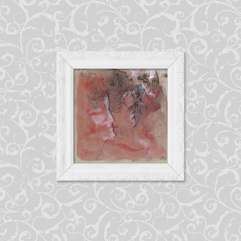 May include: A framed abstract painting with a red background and black line drawings of two faces. The faces are partially obscured by abstract shapes and lines.
