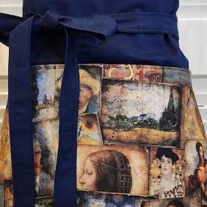 May include: A navy blue apron with a wide waistband and long ties. The apron has a patchwork design featuring famous paintings, including a starry night scene and a portrait of a woman.