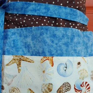 Six pocket half/server apron.  Extra long straps that can be tied in front or back.  Perfect pocket size's for server booklets.
