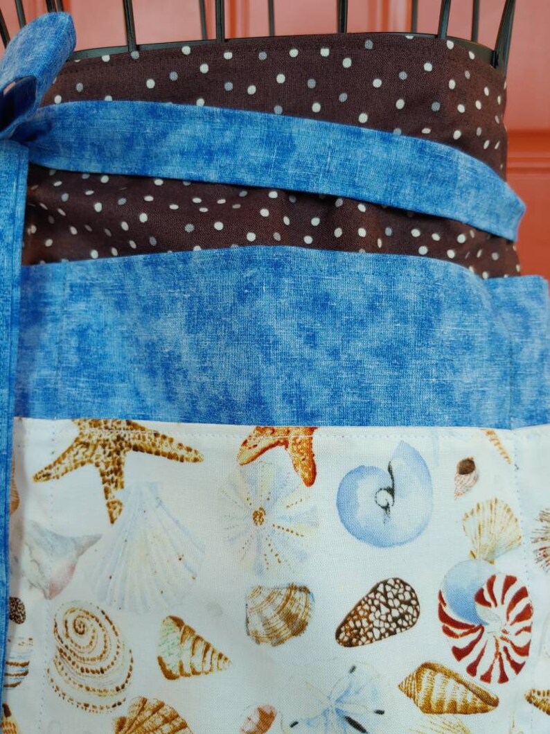 Six pocket half/server apron.  Extra long straps that can be tied in front or back.  Perfect pocket size's for server booklets.