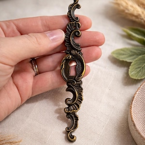 May include: A set of three ceramic mugs with a speckled, matte finish. The mugs are in shades of cream, light gray, and dark gray. Each mug has a simple, minimalist design, perfect for coffee or tea.