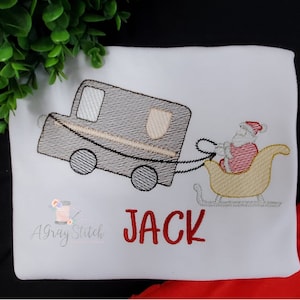 May include: Embroidered design of a gray truck pulling a yellow sleigh with Santa Claus inside. The name "JACK" is embroidered in red below the design.
