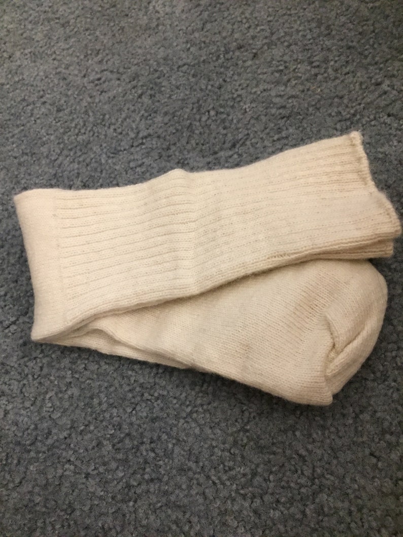May include: A pair of off-white ribbed socks folded together. The socks are made of a soft, comfortable material.