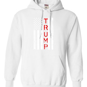 May include: White hooded sweatshirt with a red "TRUMP" printed vertically down the center of a white and gray American flag design.