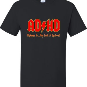 May include: Black t-shirt with a red and yellow graphic that says "AD/HD" and "Highway To....Hey Look A Squirrel!"