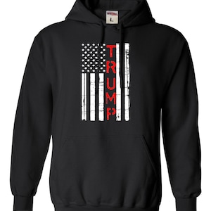 May include: Black hooded sweatshirt with a distressed American flag design and the word "TRUMP" printed vertically in red.