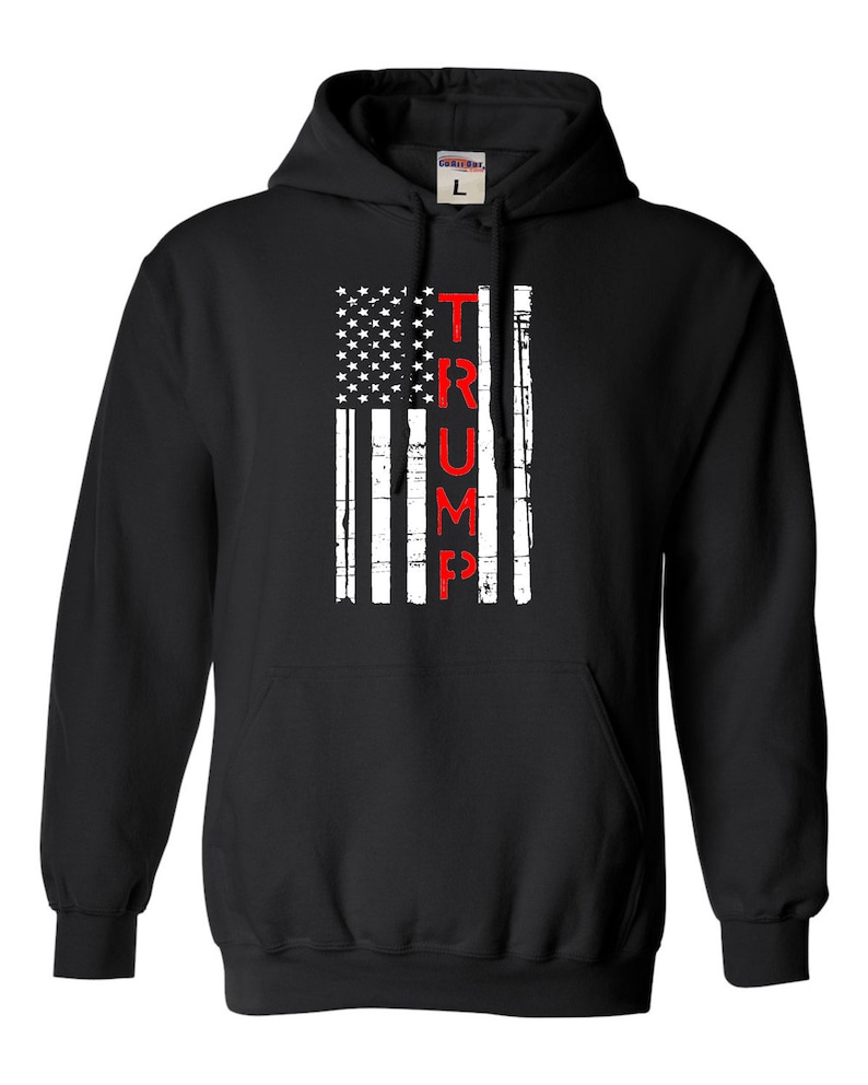 May include: Black hooded sweatshirt with a distressed American flag design and the word "TRUMP" printed vertically in red.