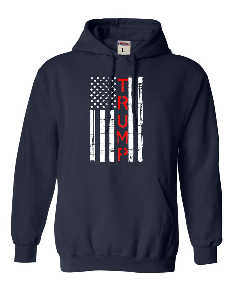 May include: Navy blue hooded sweatshirt with a distressed American flag design and the word "TRUMP" in red lettering.