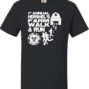 May include: Black t-shirt with white graphic text and illustrations. The text reads "1st Annual Hershel's Farm Walk & Run" with a barn and running figures. A circular logo says "For the Cure".