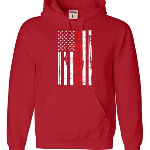 May include: Red hooded sweatshirt with a white distressed American flag design and the word "TRUMP" in red lettering.
