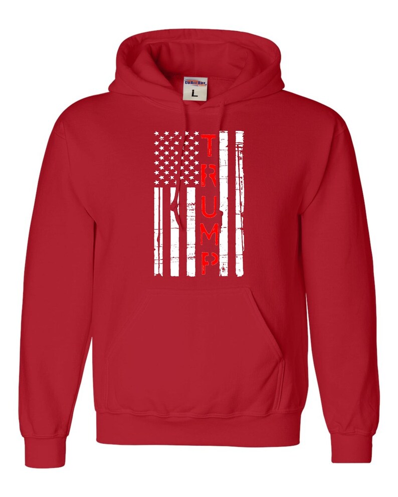 May include: Red hooded sweatshirt with a white distressed American flag design and the word "TRUMP" in red lettering.