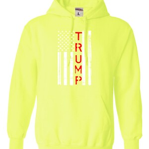 May include: A bright yellow hoodie with a white American flag and the word "TRUMP" in red lettering.