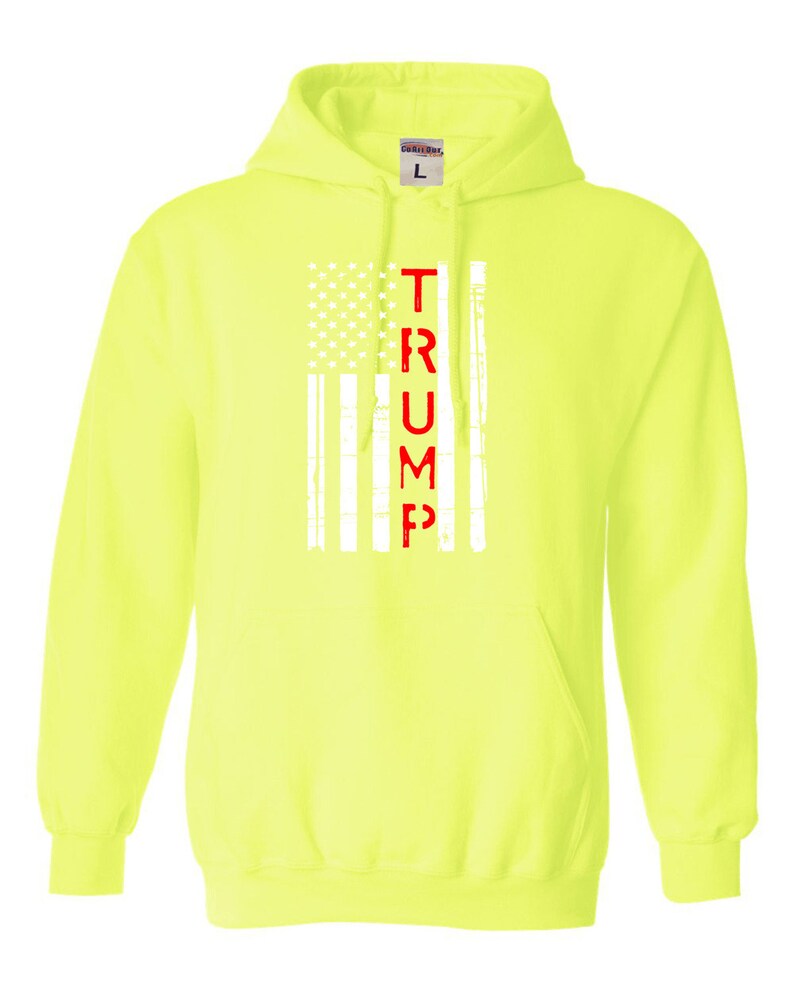 May include: A bright yellow hoodie with a white American flag and the word "TRUMP" in red lettering.